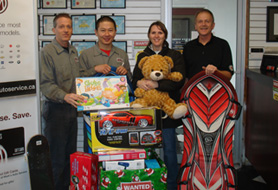 Team with Toys to Donate | Mark's Auto Service